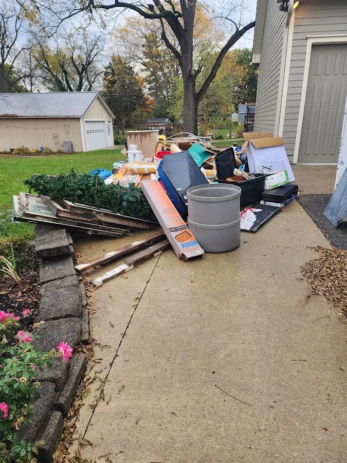 Dumpster being loaded with debris for Estate Cleanout Dumpster Rental in Terrell